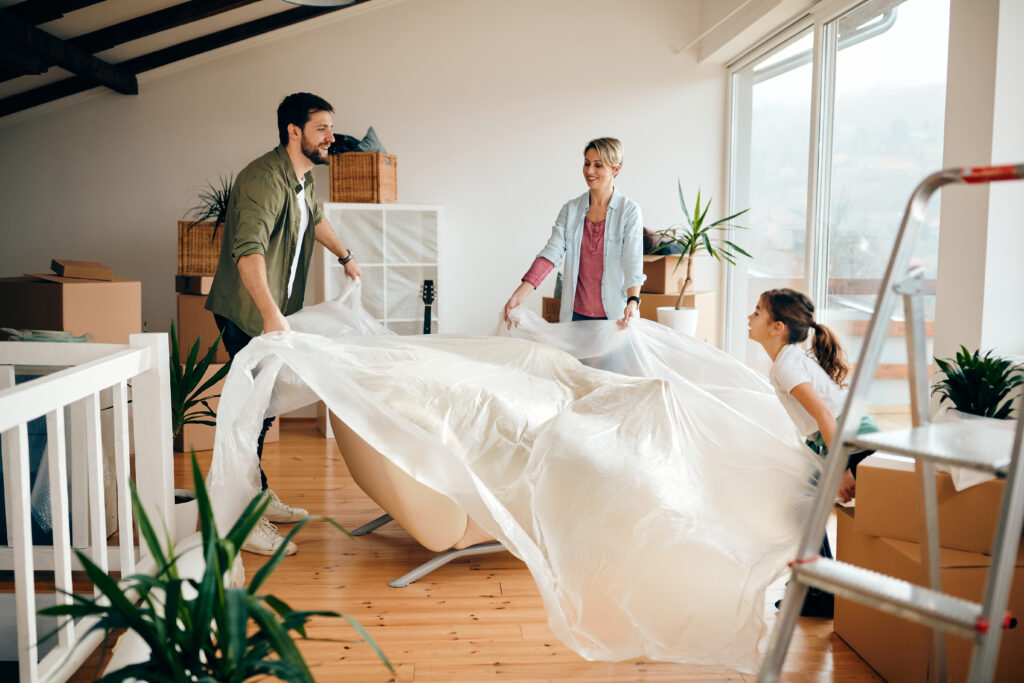 Family packing their own boxes to save on moving costs in Melbourne
